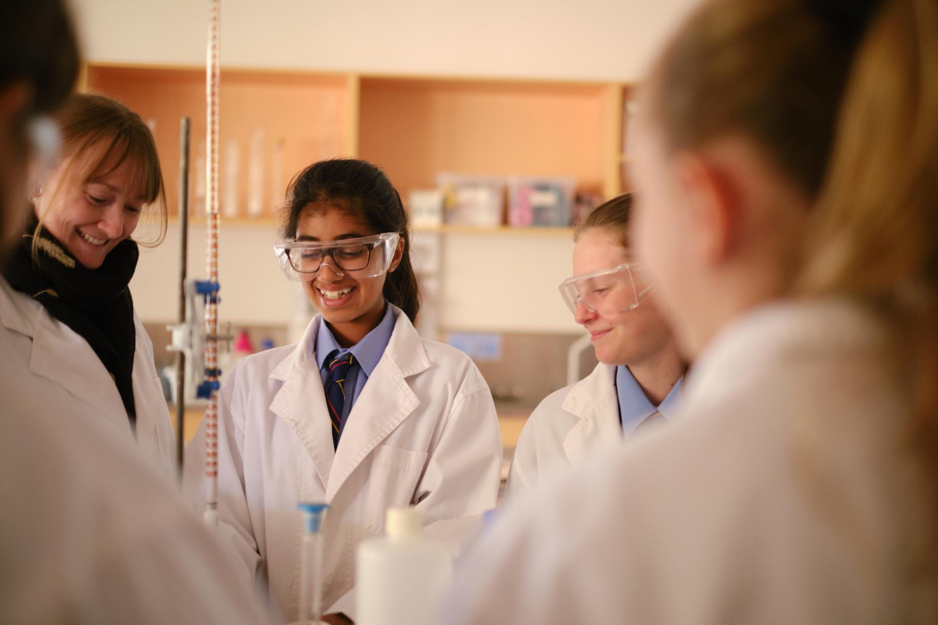 Indian female student learning in a science lab. 