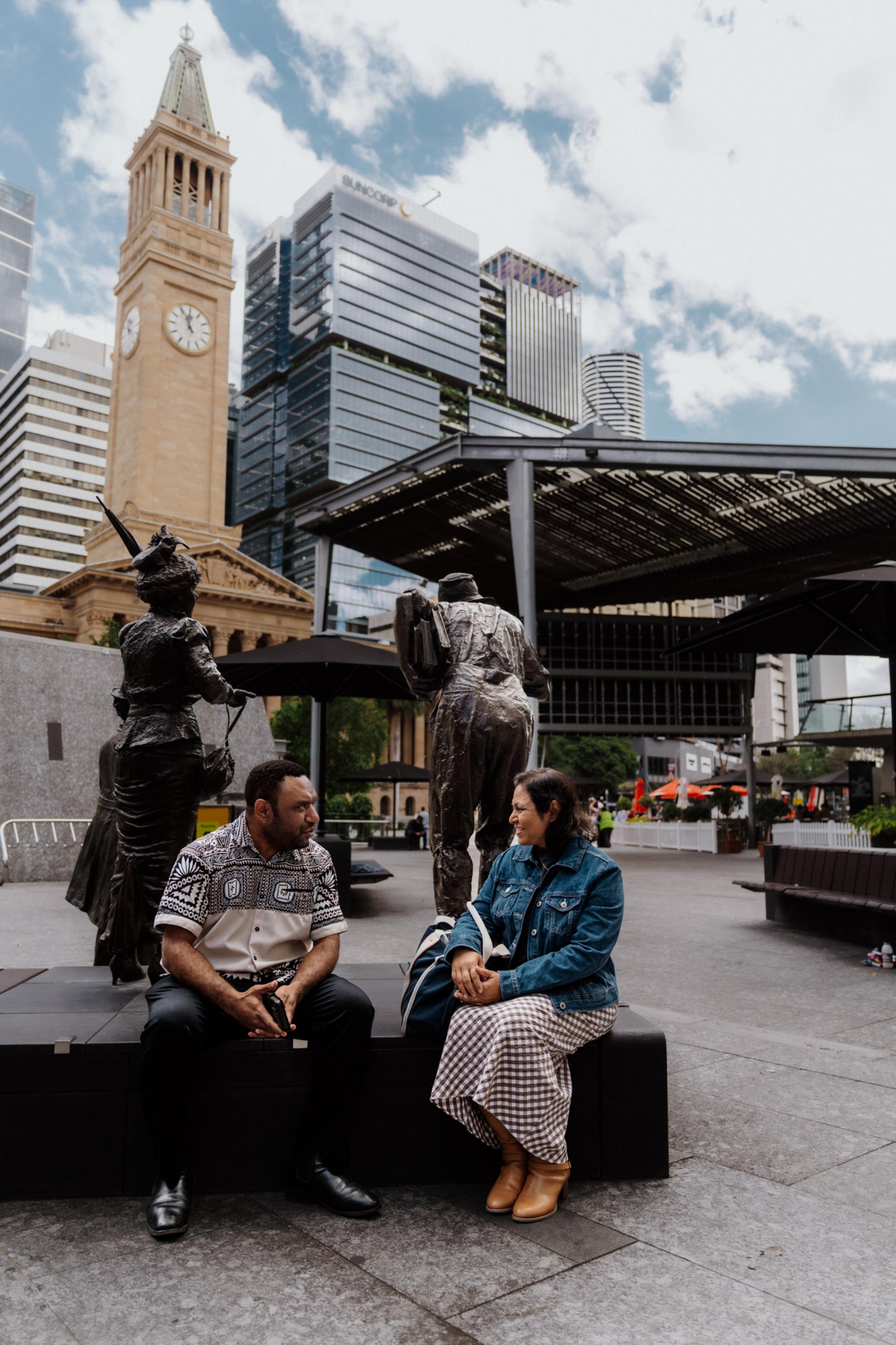 Two students sitting together in the Brisbane CBD. 