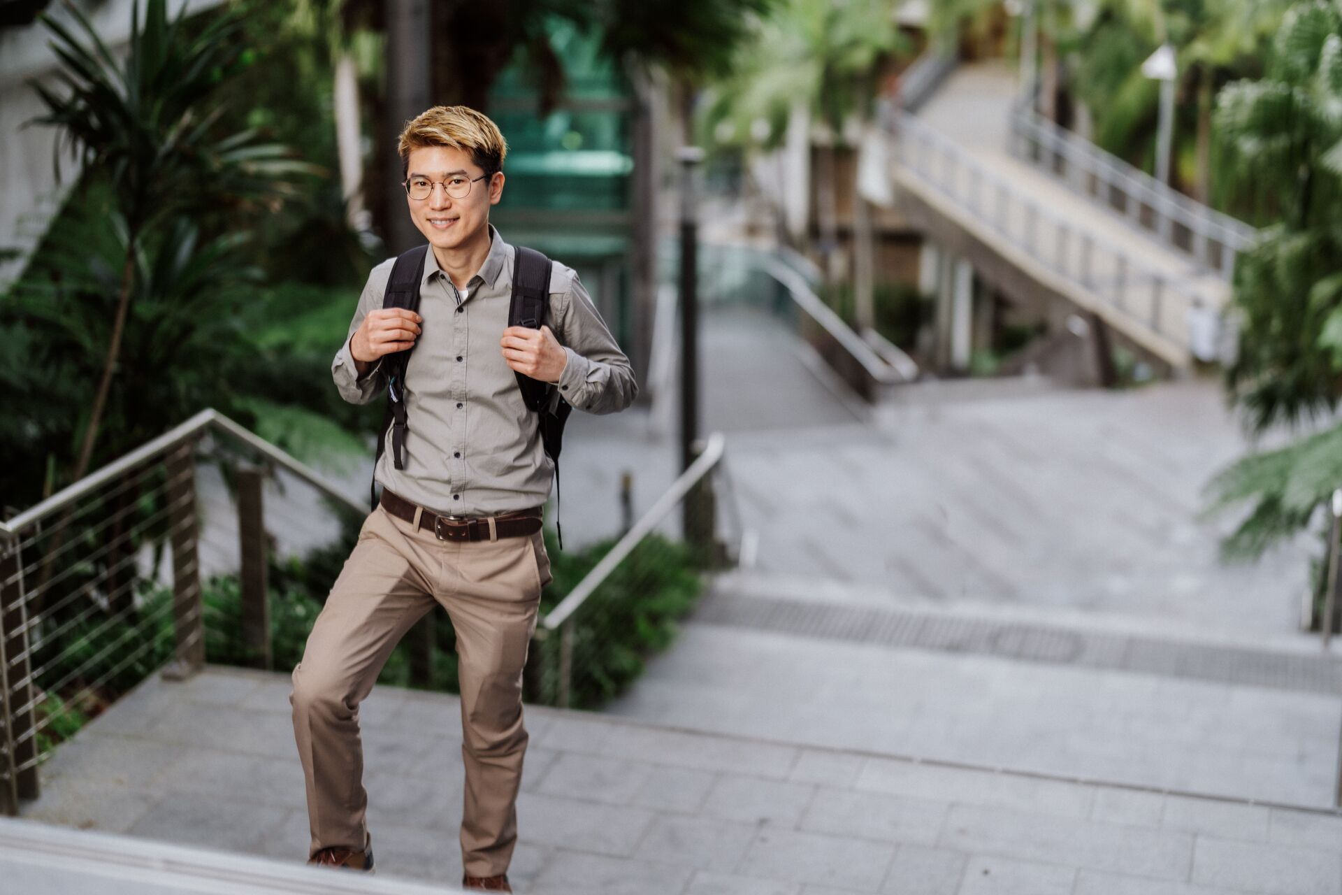 Male student walking up a set of stairs at the Queensland University of Technology, Kelvin Grove campus. 